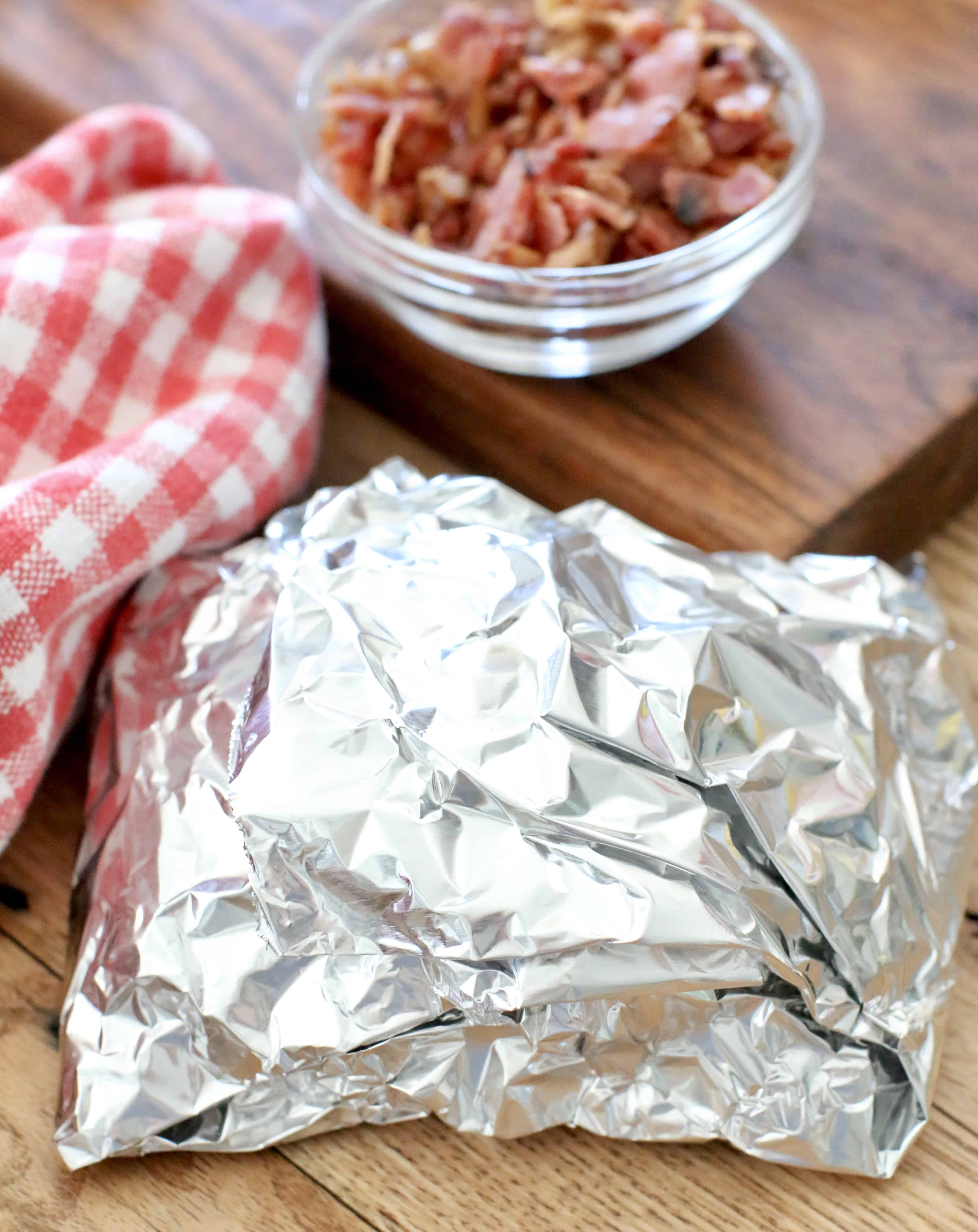 potatoes, cheese and shredded pork BBQ wrapped in aluminum foil.