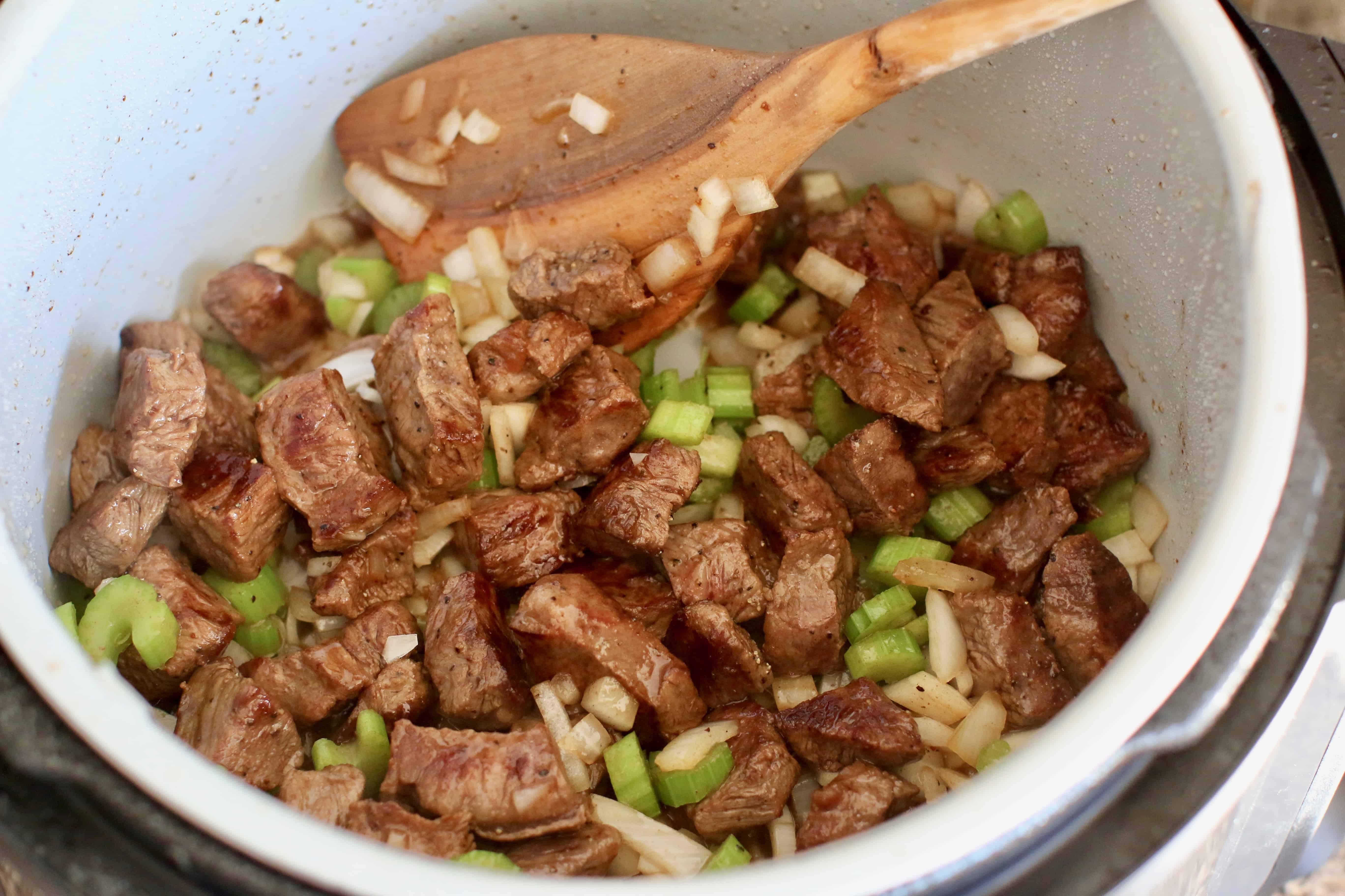 browned meat with diced celery and onion in an instant pot