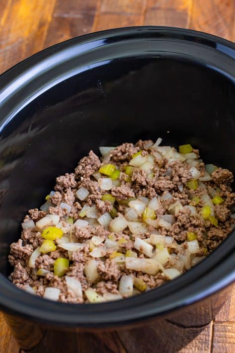 cooked ground beef in the bottom of the slow cooker.