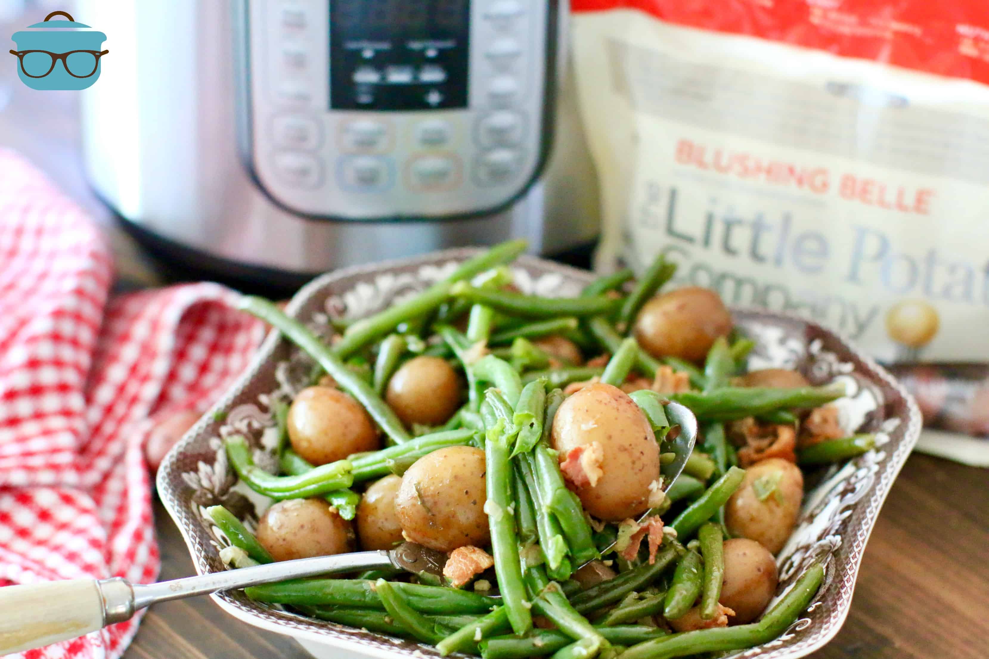 Instant Pot Garlic Green Beans and Bacon with Potatoes shown in a brown and white bowl.