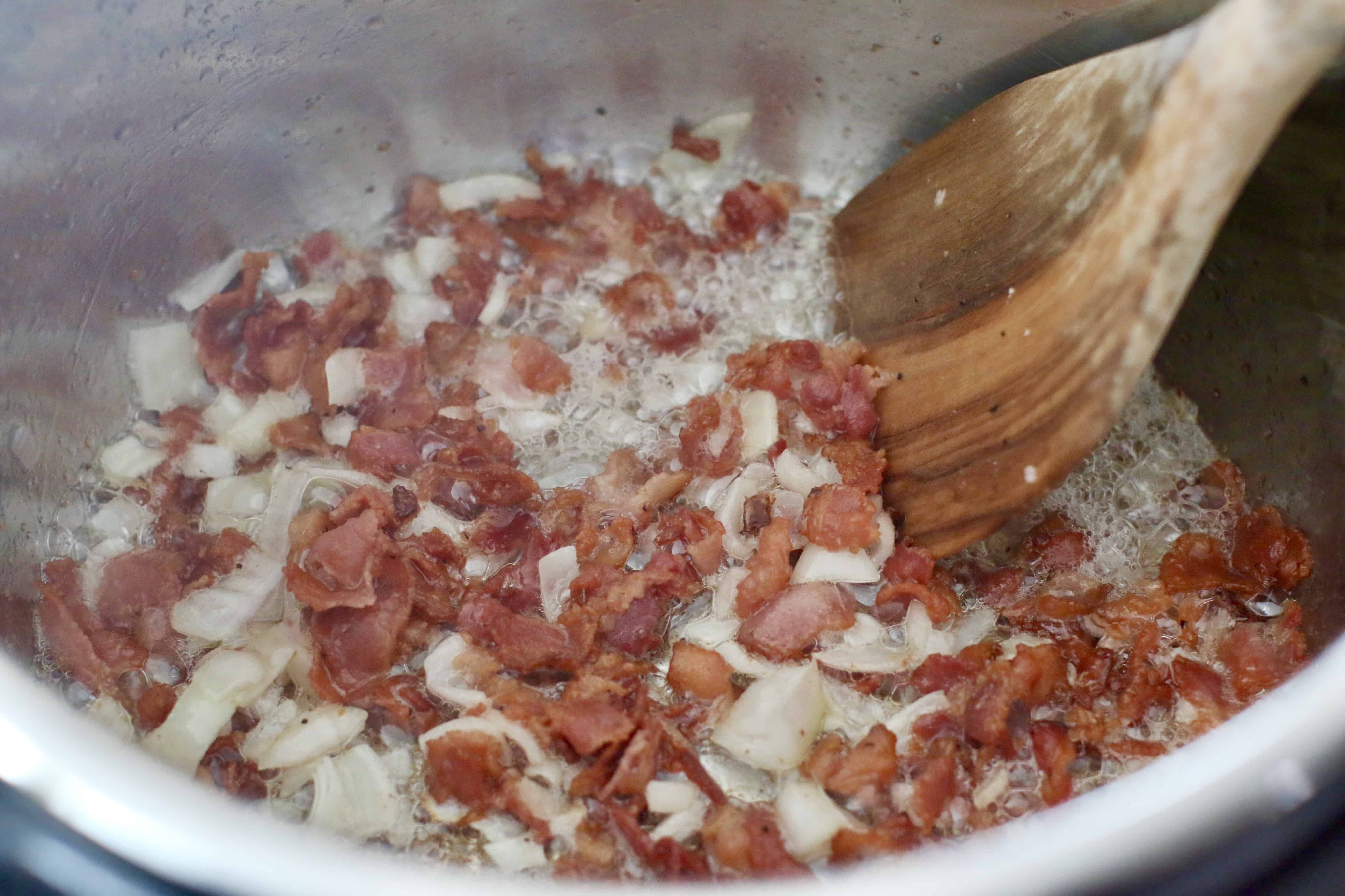 diced shallot added to cooked bacon in pressure cooker pot.