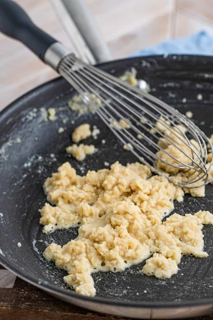 flour and butter cooked together in a pan with a whisk.