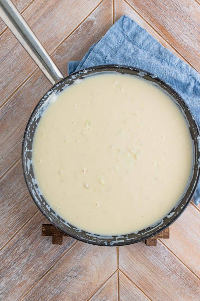 thickened cream mixture shown in a large skillet.