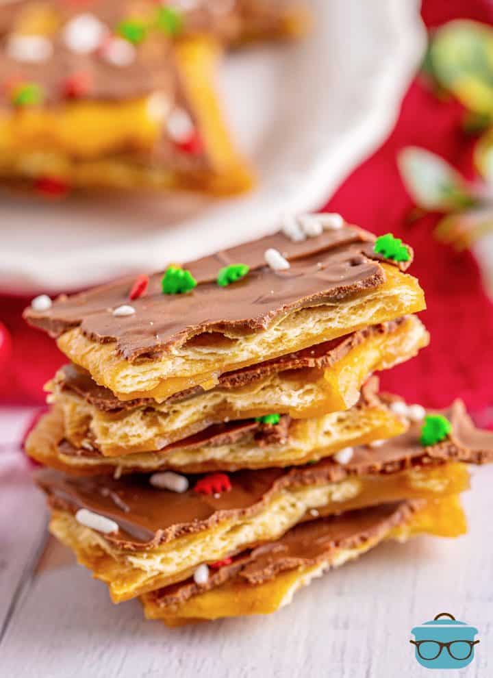 a tall stack of Christmas Crack on a white wood surface. 