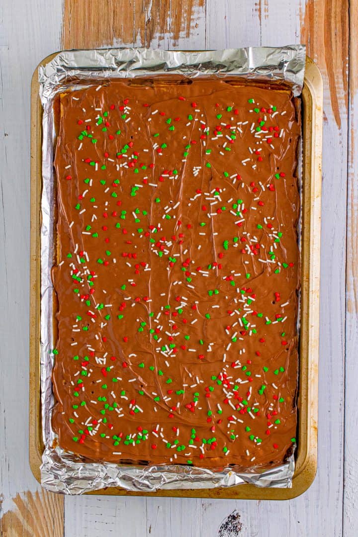 melted chocolate evenly spread on top of crackers and topped with Christmas colored sprinkles.