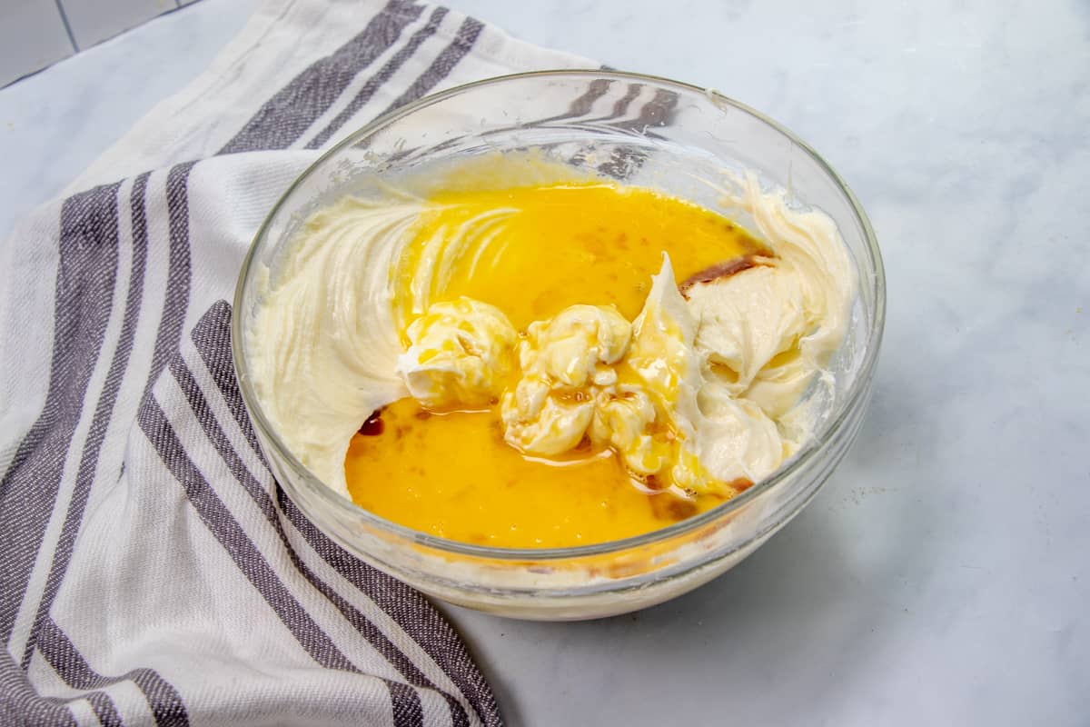 sour cream, melted butter and beaten eggs added to cream cheese mixture in a large bowl.