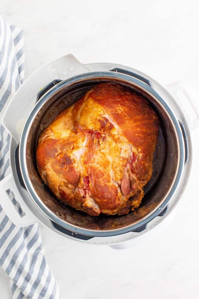 fully cooked ham shown inside the instant pot appliance 