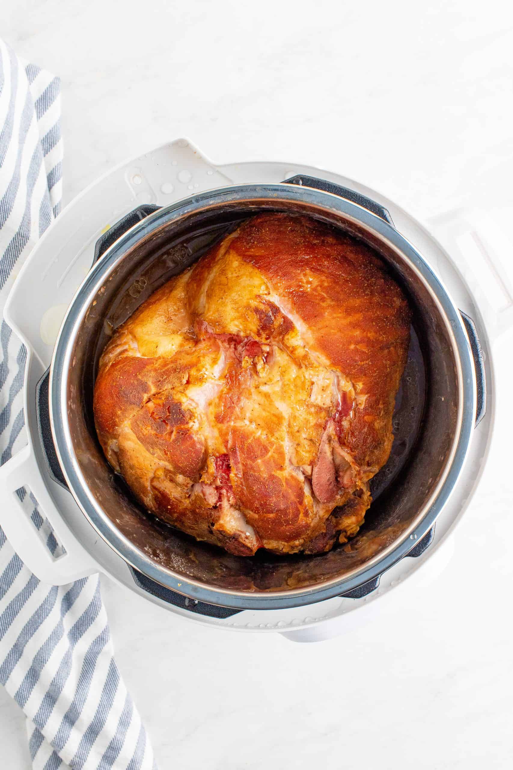 fully cooked ham shown inside the instant pot appliance. 