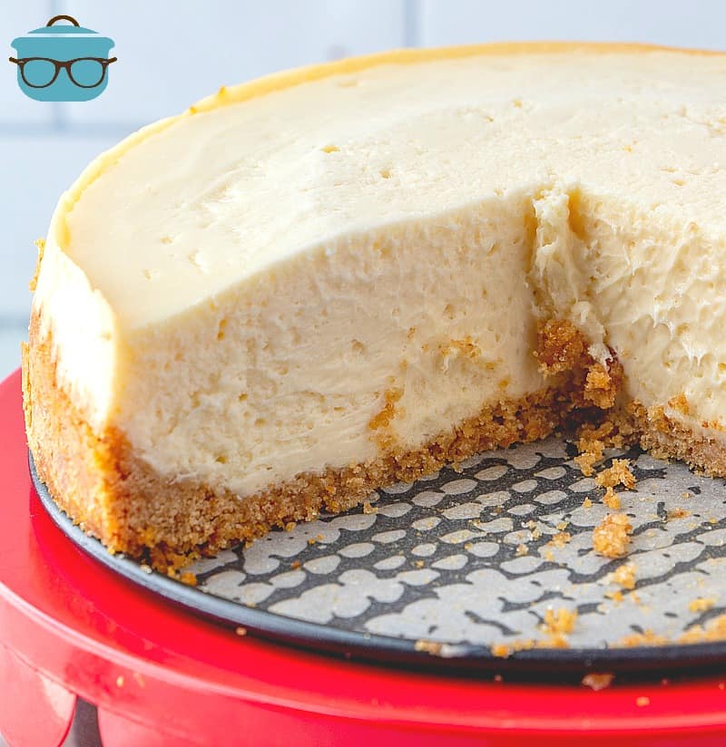 sliced, Instant Pot Cheesecake on a cake stand.