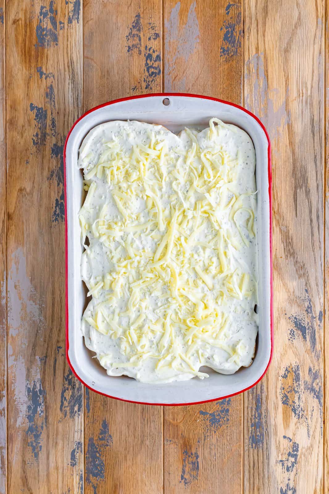 shredded mozzarella cheese shown sprinkled over cream cheese layer. 
