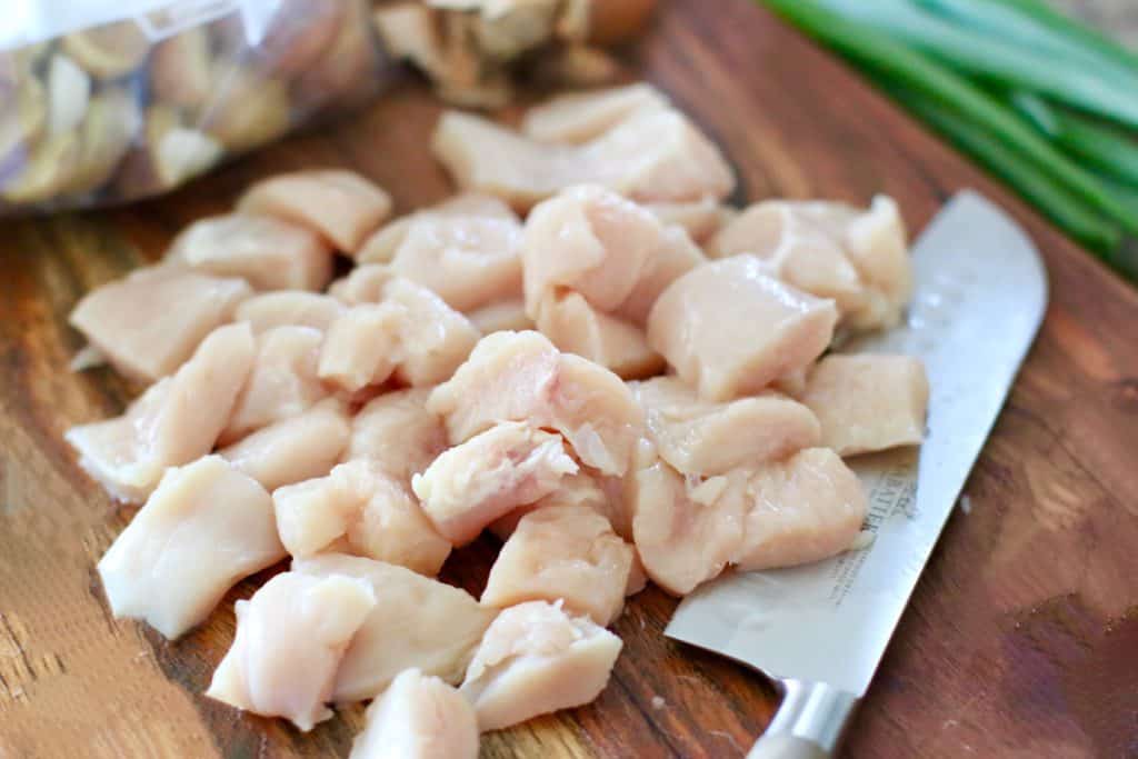 diced, fresh chicken breast on a cutting board