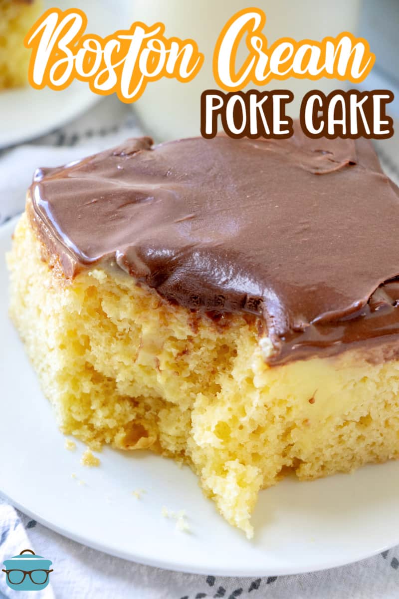 slice of Boston cream poke cake on a small round white plate with a bite removed from the cake. 