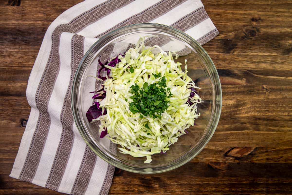 finely shredded green and red cabbage added to homemade Cole slaw seasoning.