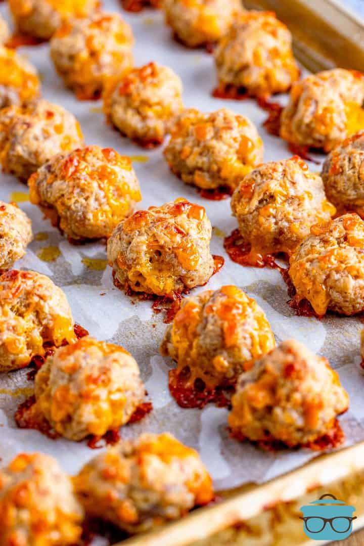 fully baked creamy cheese sausage balls on a baking sheet.