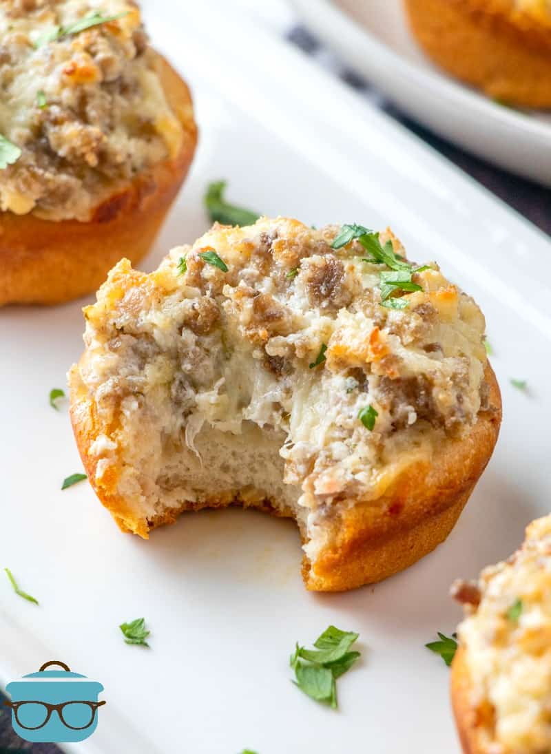 Cream Cheese Sausage Stuffed Biscuits on a white serving platter.