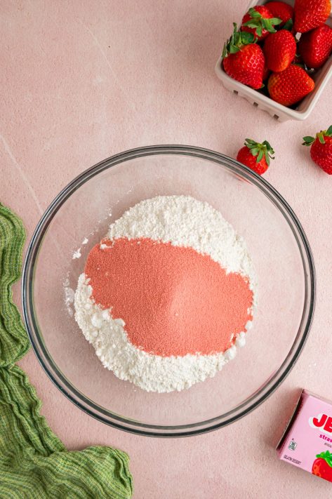 Cake mix and strawberry jell-o mix in a bowl.