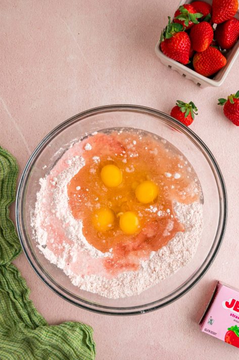 Oil, eggs, and water being added to a cake mix.