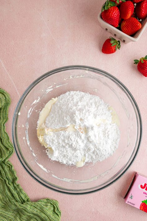 Powdered sugar and milk being added to make a frosting.