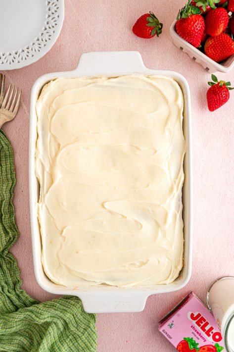 A frosted Strawberry Cake in a baking dish.