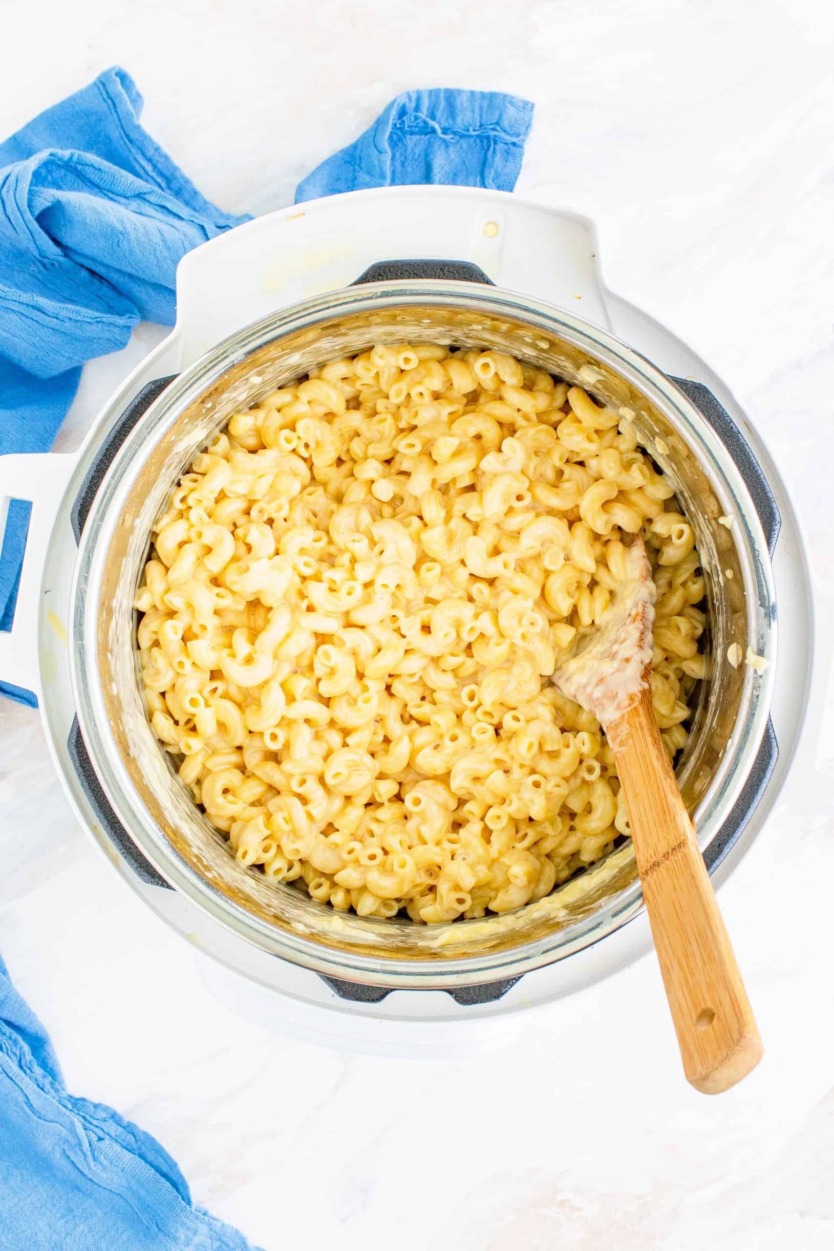 milk, cheese and macaroni noodles stirred together in an Instant Pot.