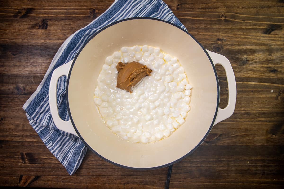 creamy peanut butter added to melted marshmallows and butter in a sauce pot