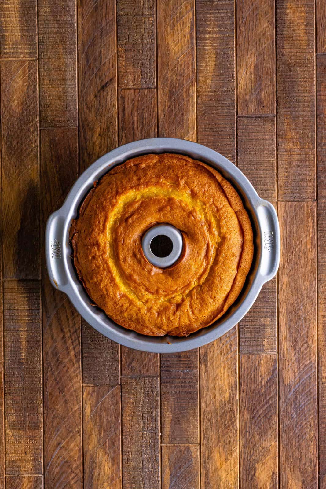 fully baked 7Up cake shown in a bundt pan on a wooden surface.