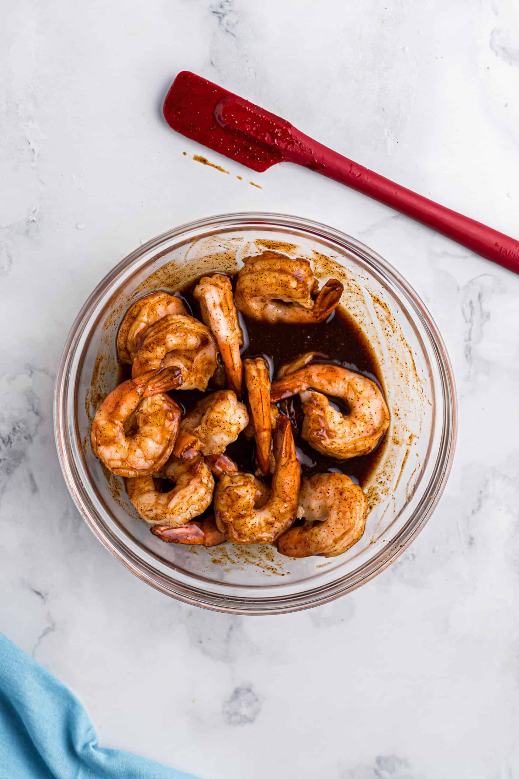 cooked shrimp in a bowl mixed together with barbecue sauce, soy sauce and Worcestershire sauce.