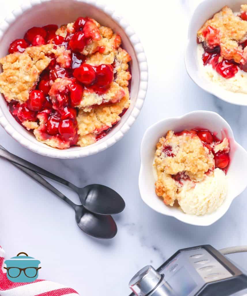 Electric Pressure cooker cherry cobbler served in white bowls with silver spoons