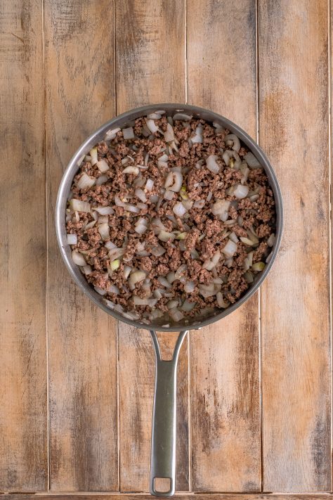browned and crumbled ground beef with onion in a large skillet.