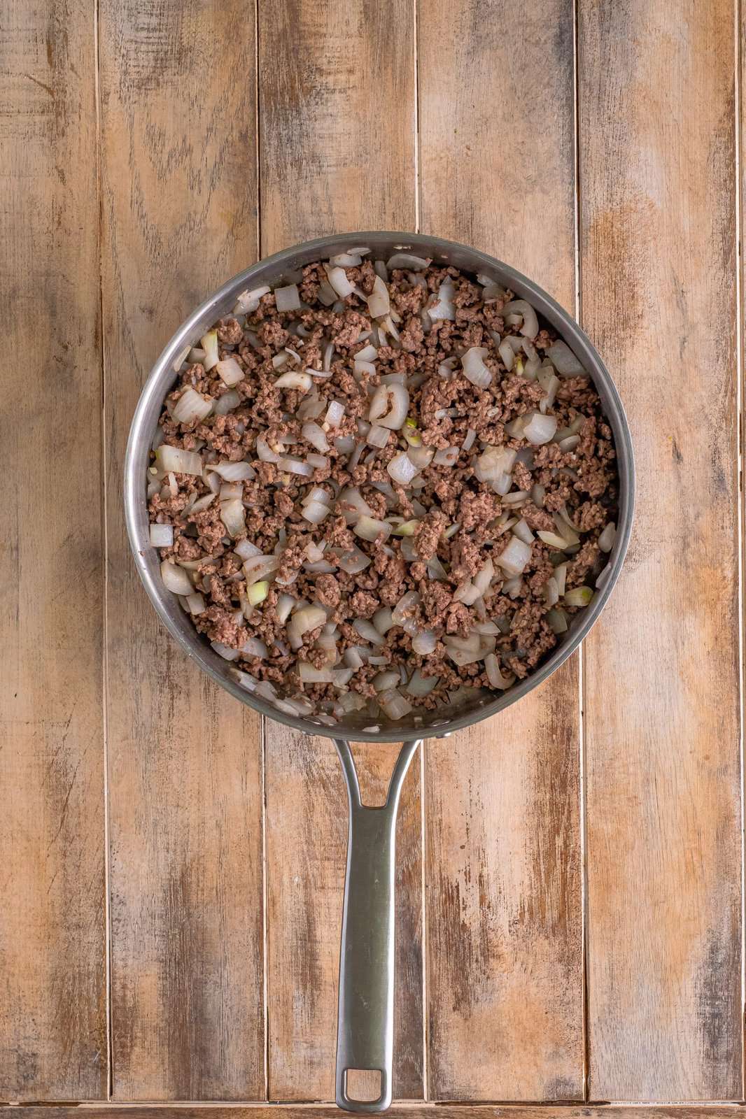 browned and crumbled ground beef with onion in a large skillet. 