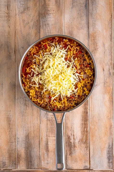shredded mozzarella cheese added to skillet.