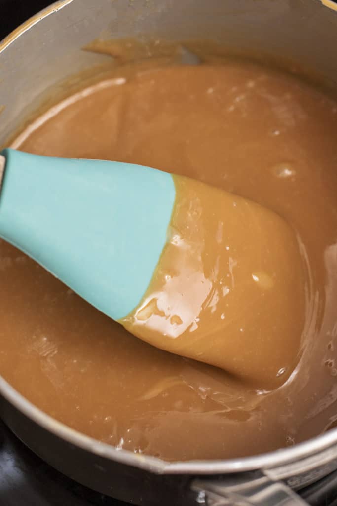 melted caramel in saucepan with a spoon