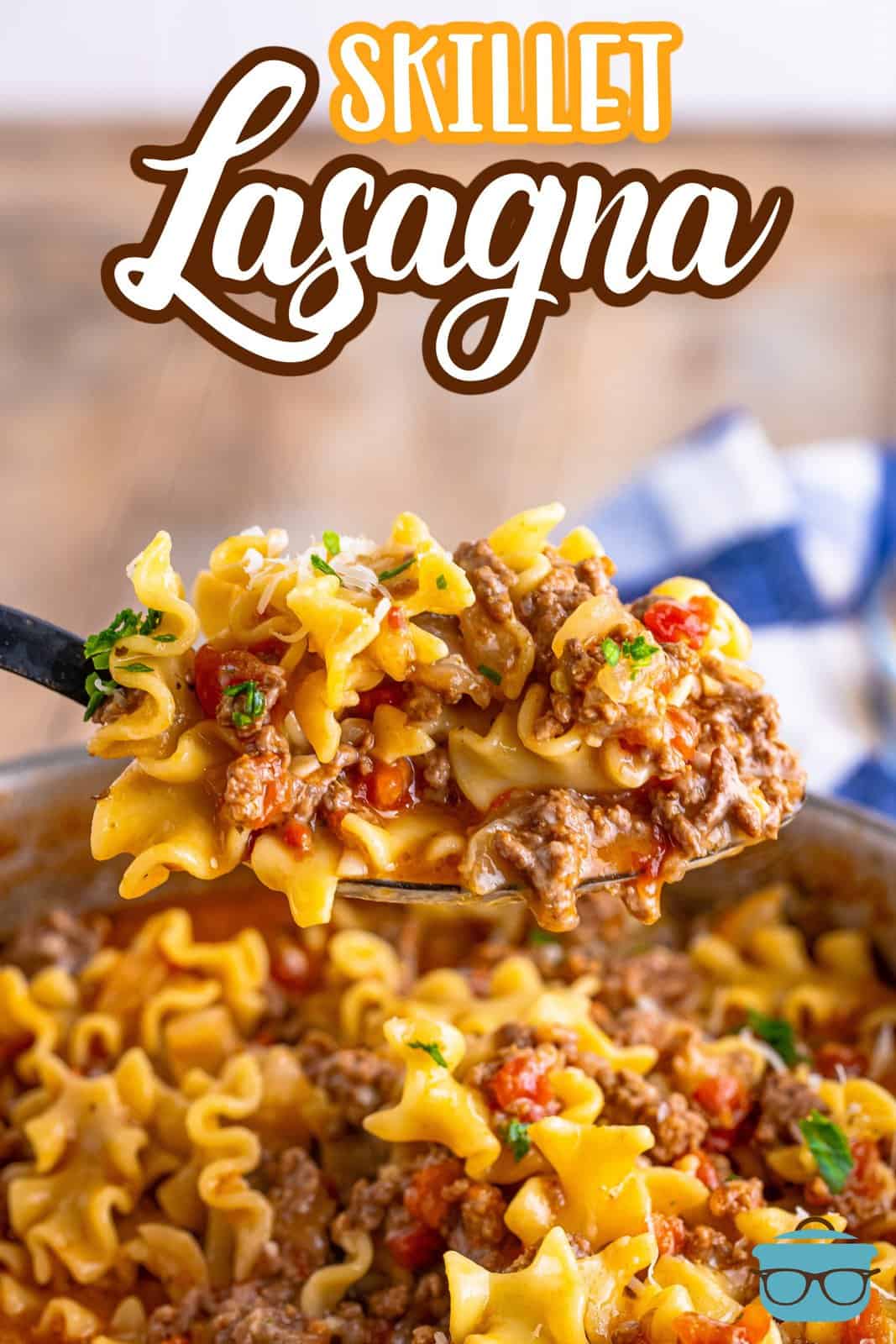 a spoon scooping up a serving of skillet lasagna and holding it over the pan.