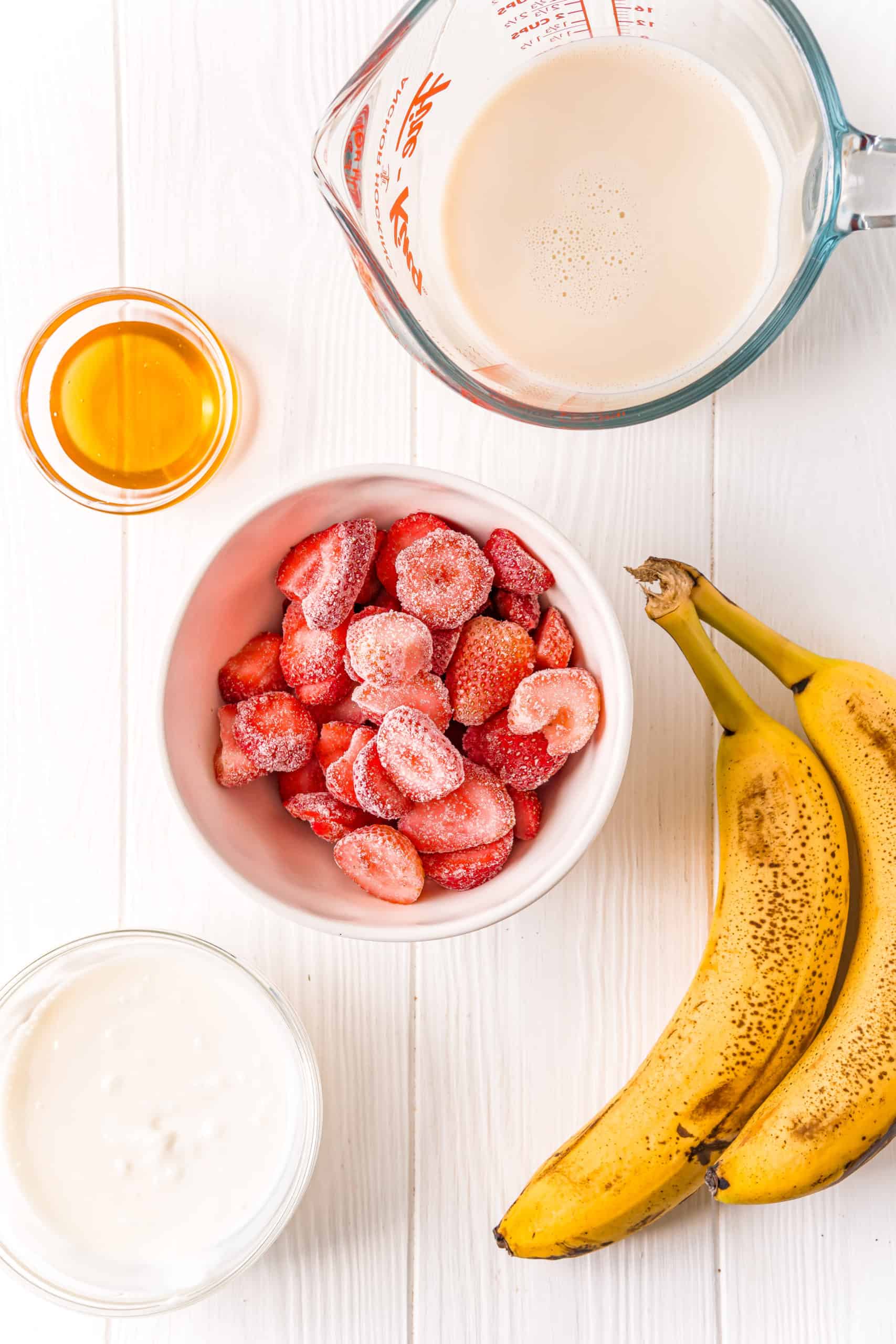 frozen strawberries, bananas, almond milk, plain Greek yogurt, honey.