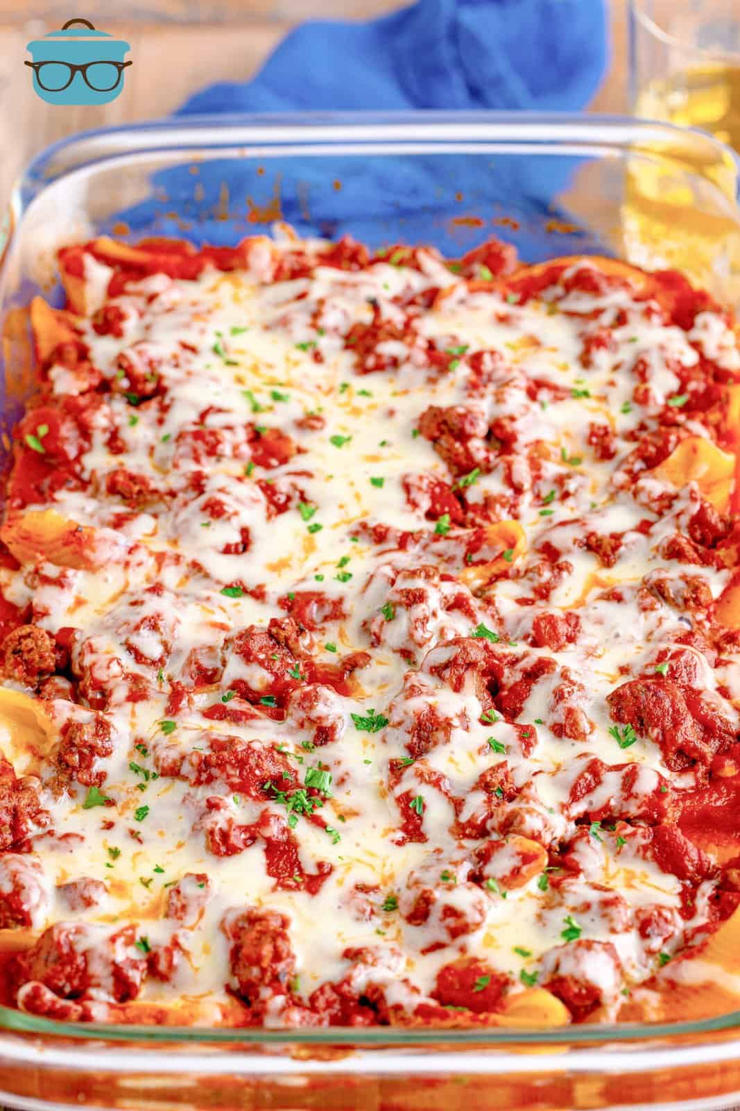 fully cooked stuffed shells in a clear baking dish.