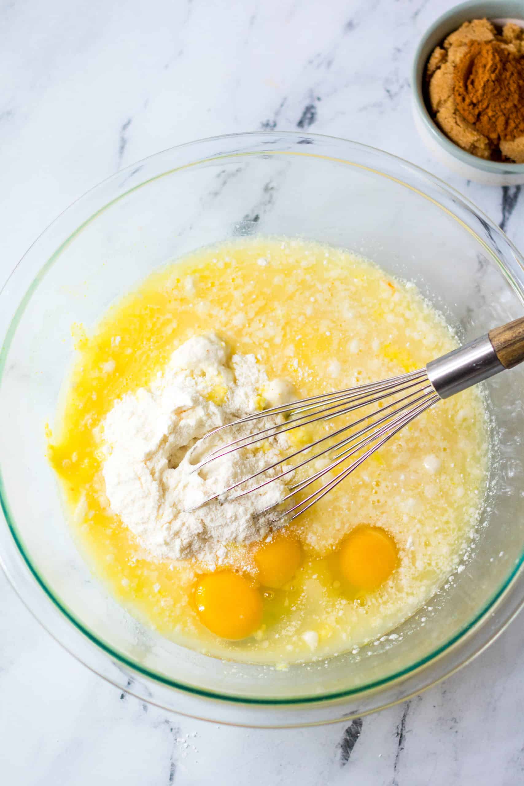 cake mix, eggs, oil in water in a mixing bowl with a whisk