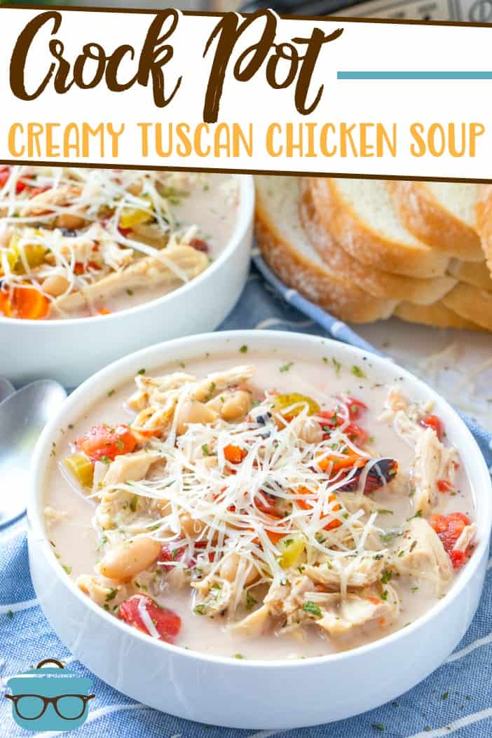 Crock Pot Creamy Tuscan Chicken Soup recipe from The Country Cook, pictured served into two white bowls with Italian sliced bread in the background.