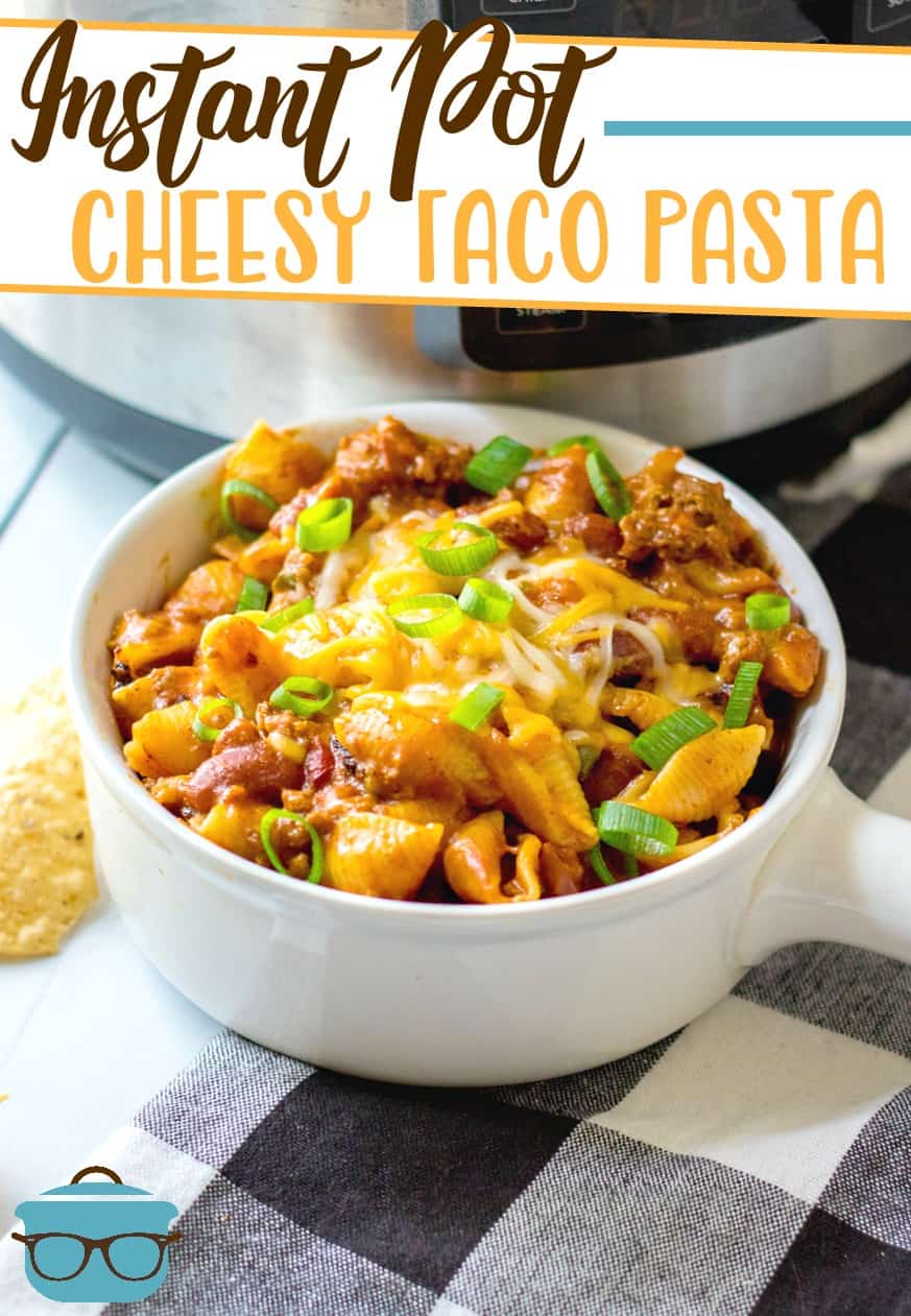 Instant Pot Cheesy Taco Pasta recipe from The Country Cook, shown served in a white bowl with an electric pressure cooker in the background.