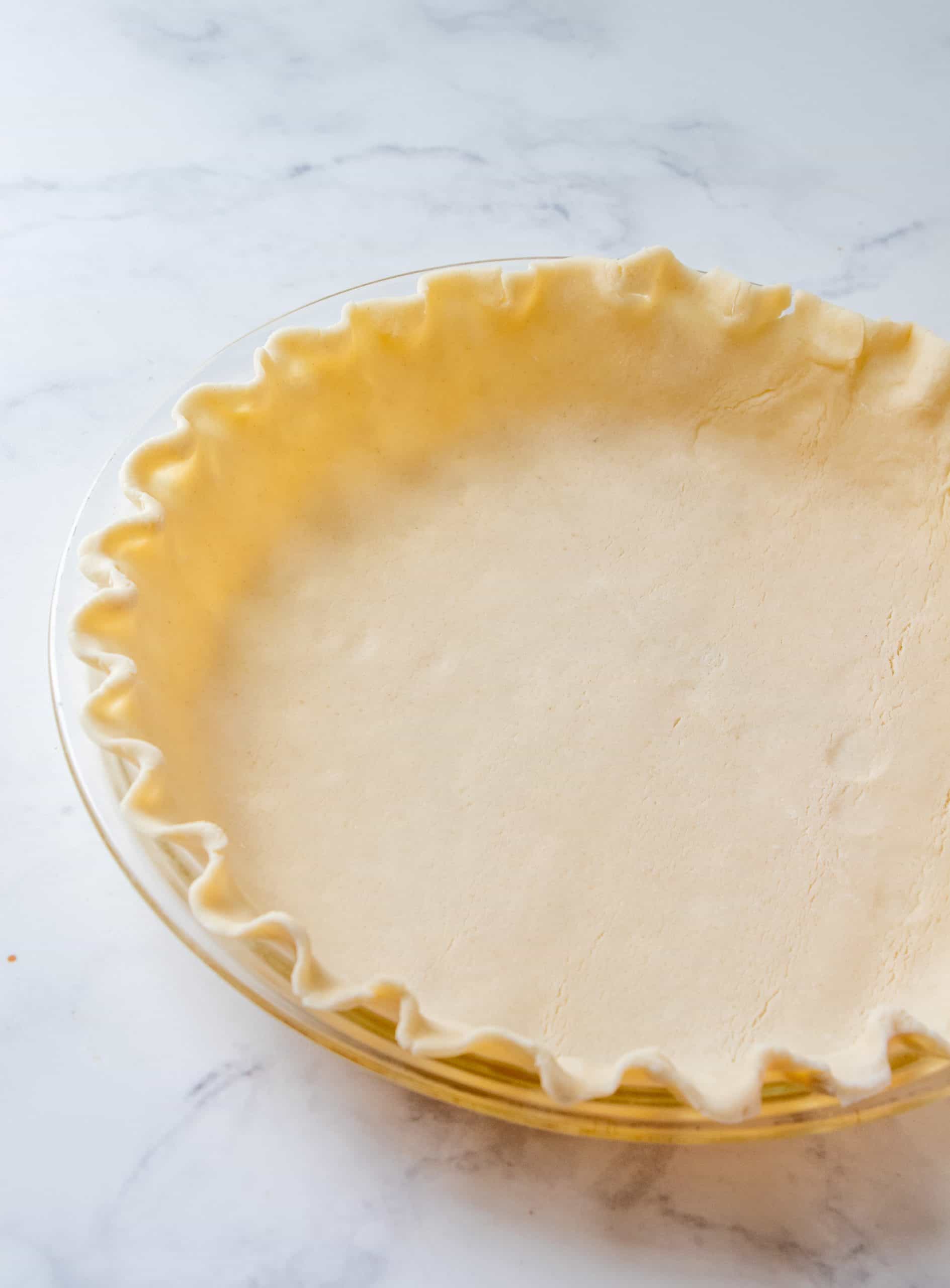 refrigerated pie crust pressed into a pie pan with fluted pie edges