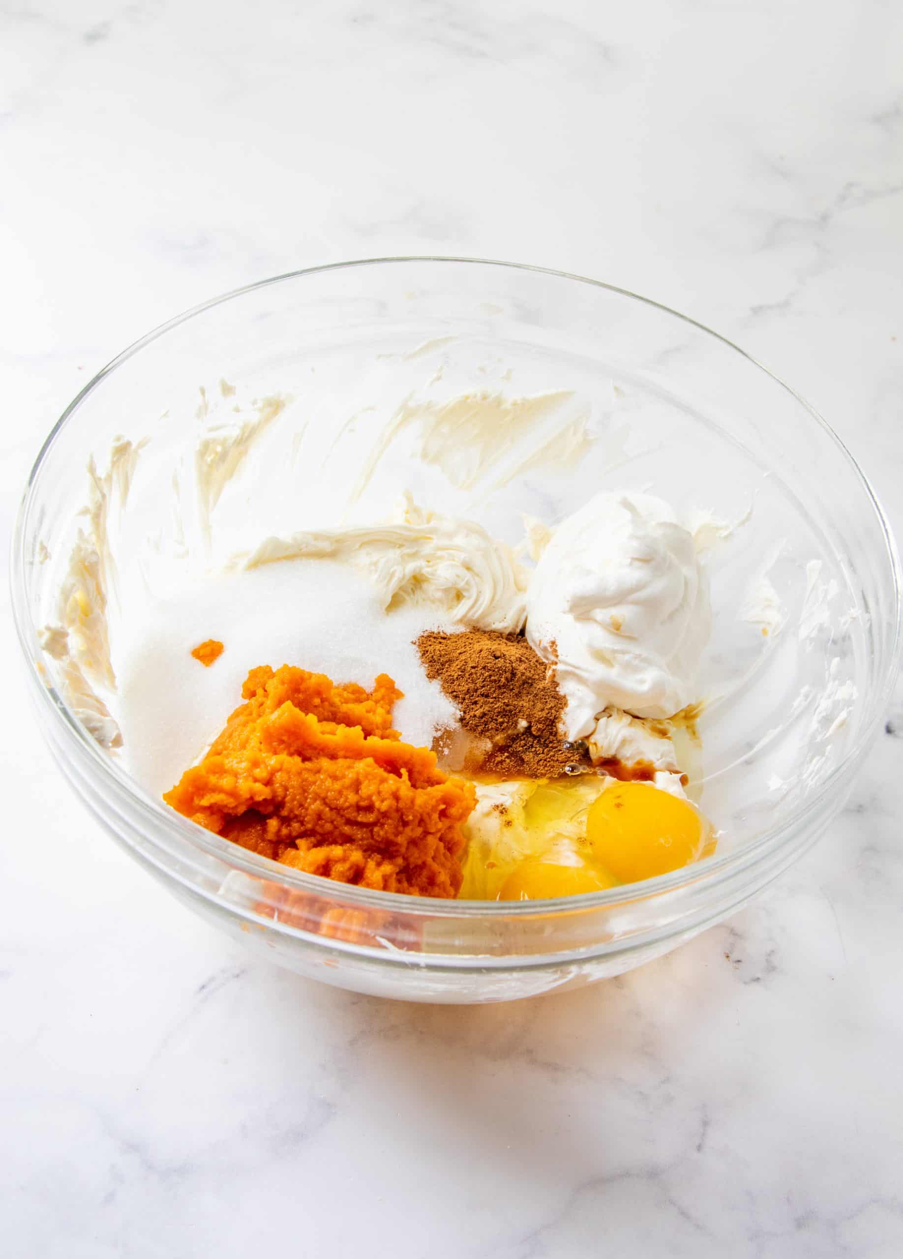 eggs, pumpkin puree and pumpkin pie spice added to softened cream cheese mixture.