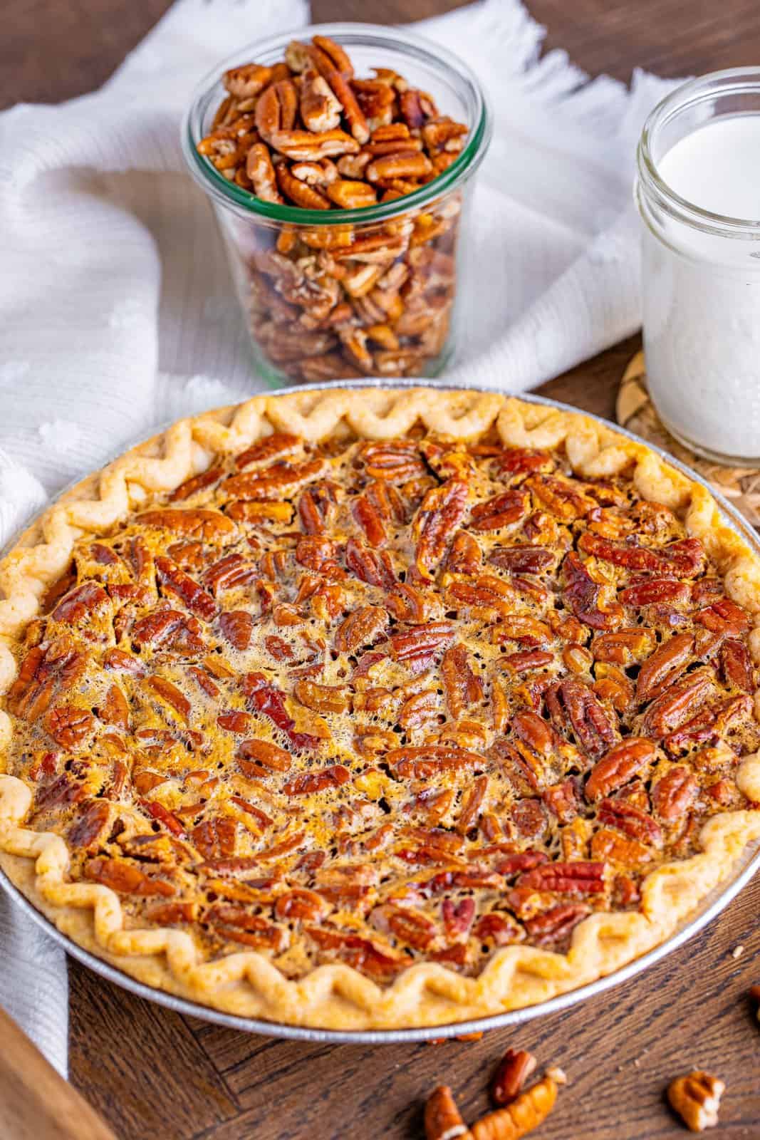 fully cooked pecan pie on a wooden surface.