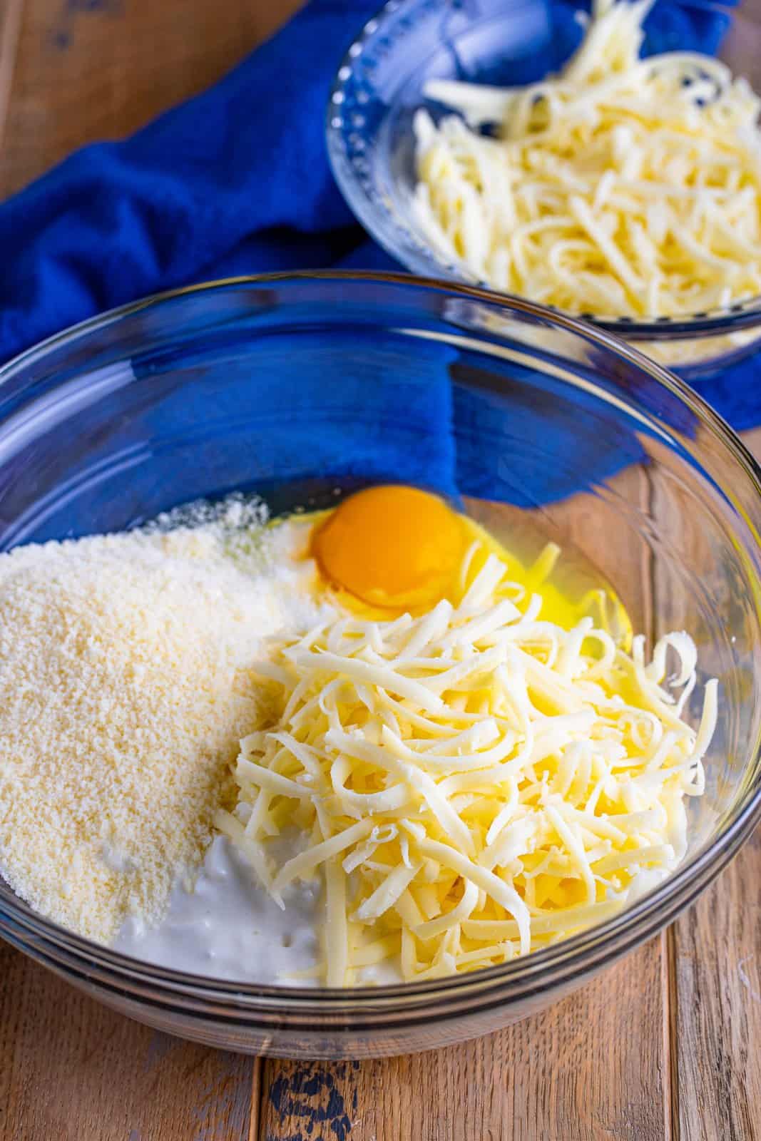 cottage cheese, mozzarella, parmesan and egg in a clear bowl.