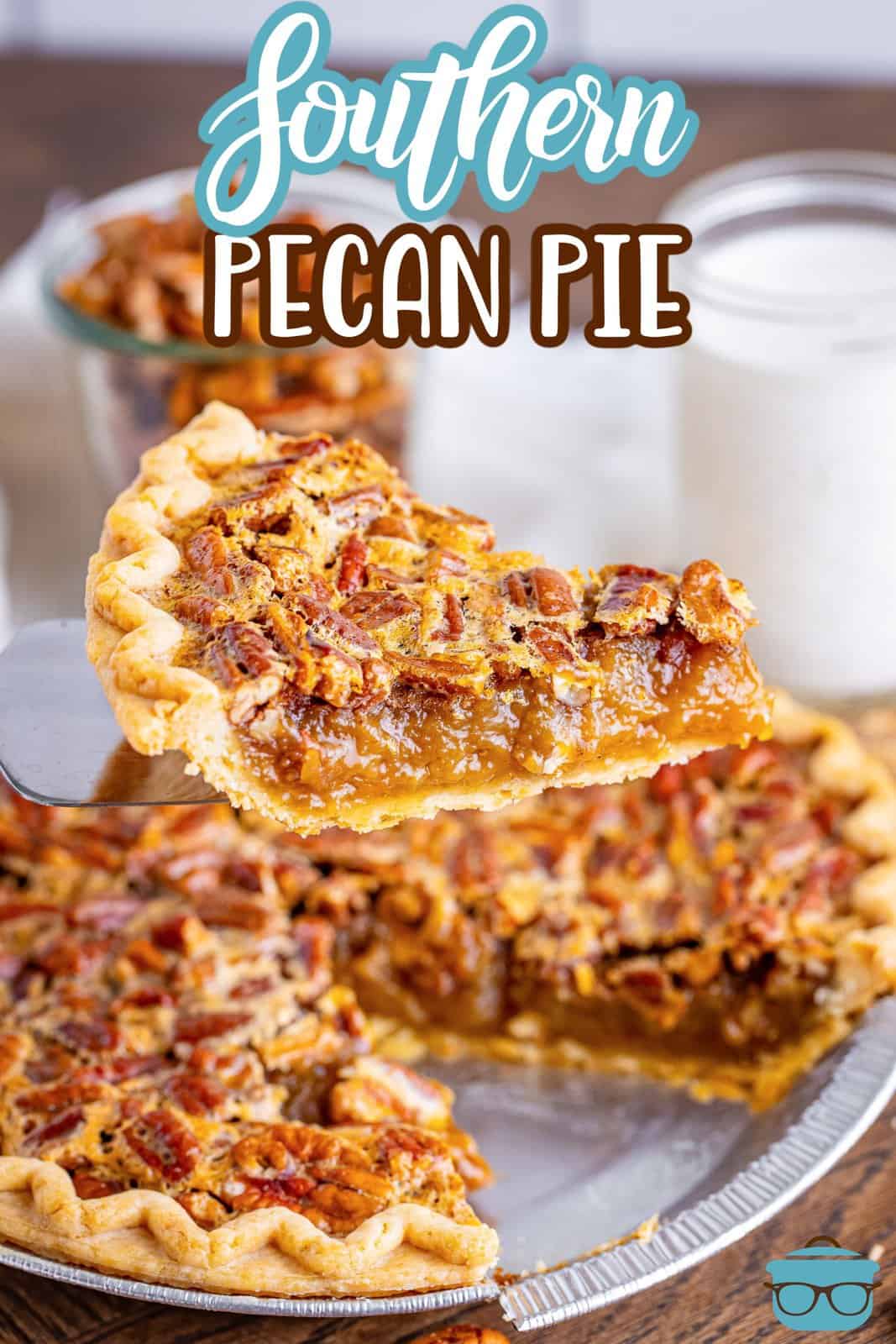 a slice of pecan pie being removed from the rest of the pie. 