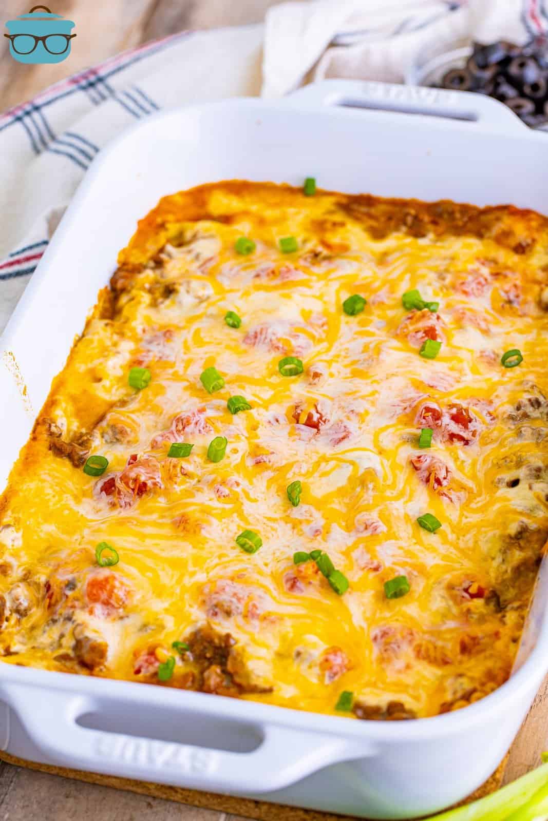 fully baked Mexican Lasagna in a white baking dish. 