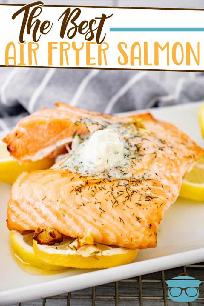 The Best Air Fryer Salmon with Lemon Garlic Dill Butter recipe from The Country Cook, salmon shown on a white plate and sitting on a bed of sliced lemon