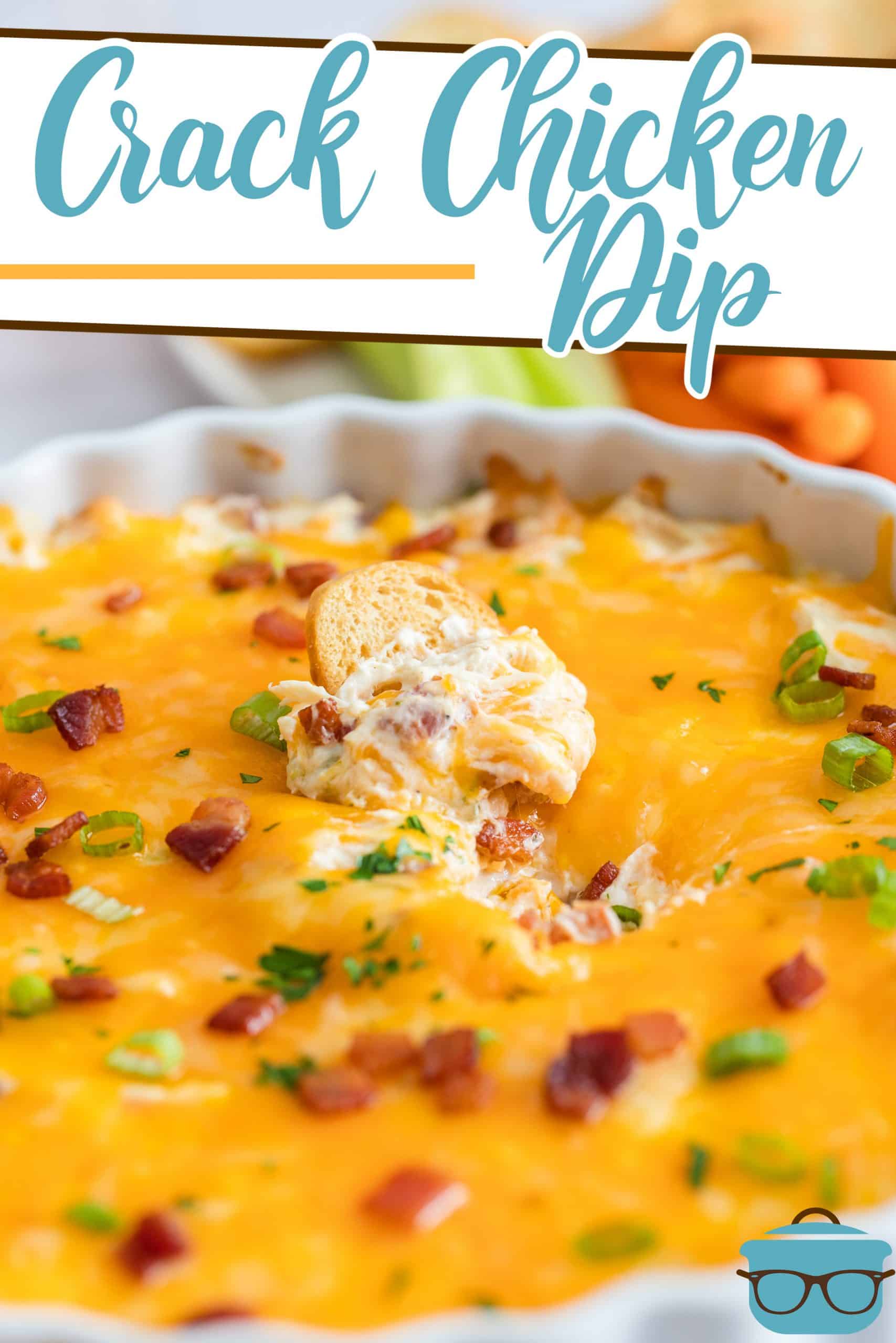 The Best Crack Chicken Dip recipe from The Country Cook, shown fully cooked in a white baking dish with a chip dipped in the center.