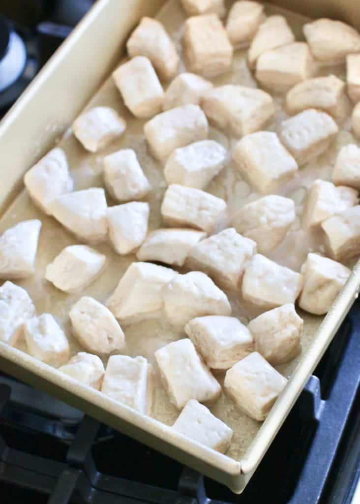 cut biscuits spread out in a baking dish