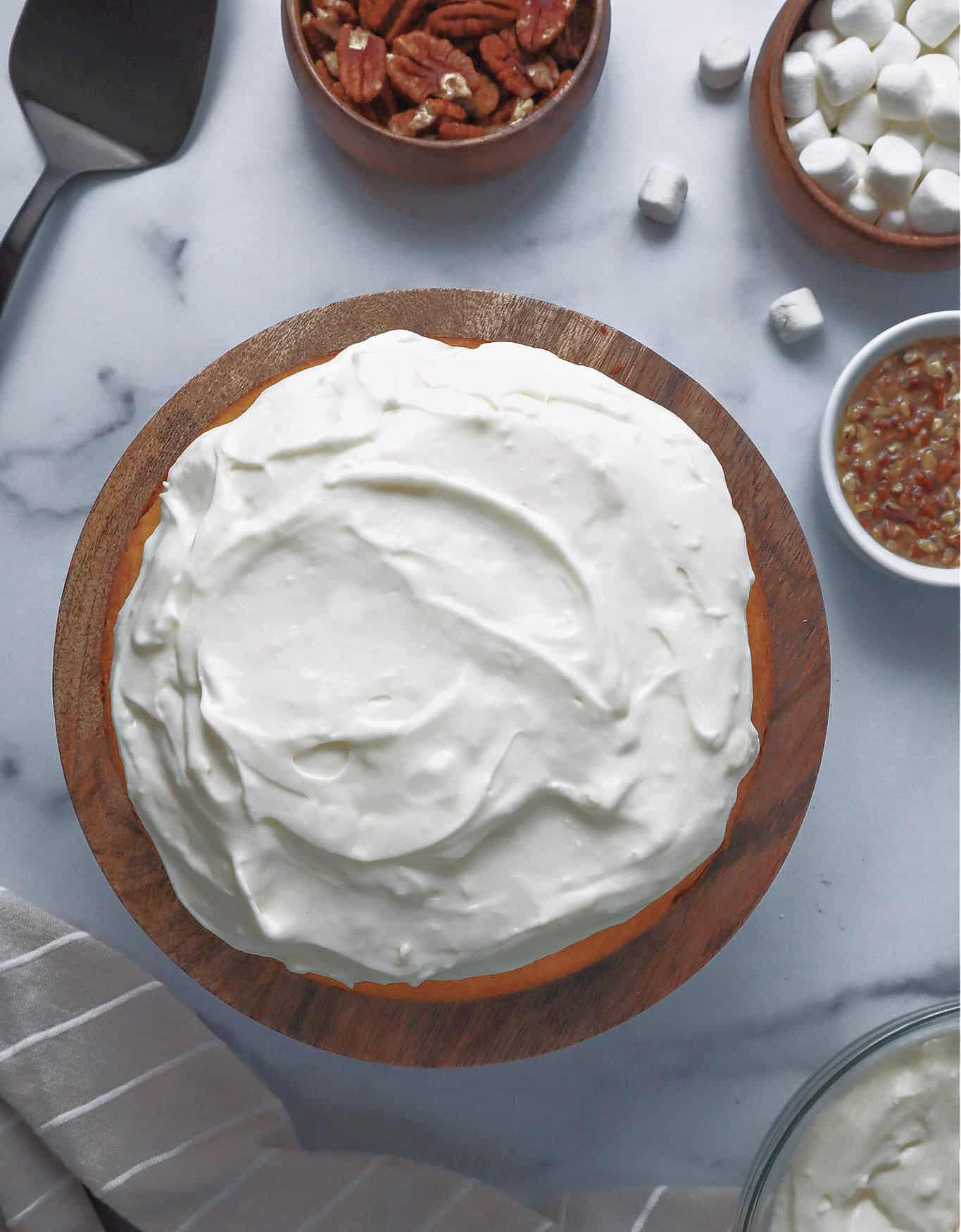 marshmallow frosting spread on top of sweet potato cake layer.
