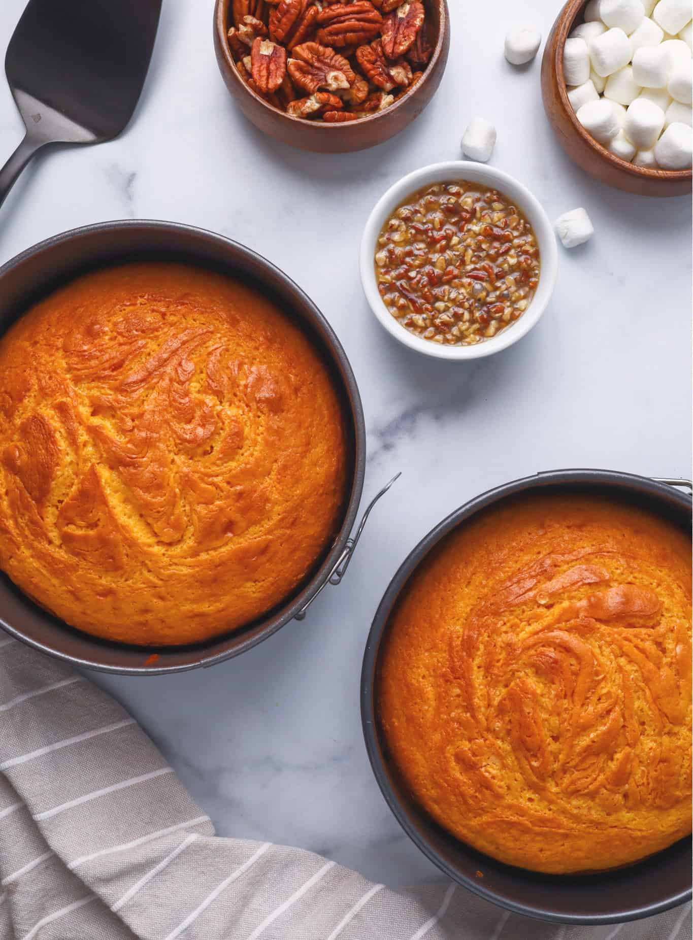 fully baked. sweet potato cake layers in springform pans cooling on a counter