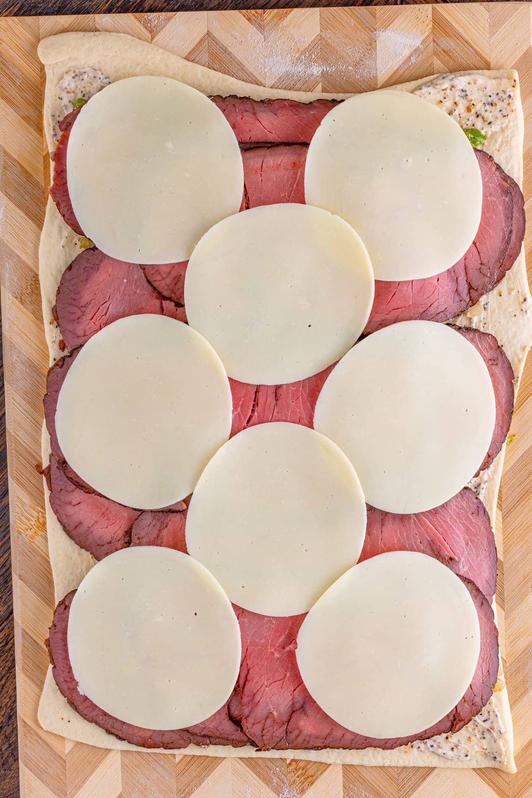 slices of provolone layered across sliced roast beef.
